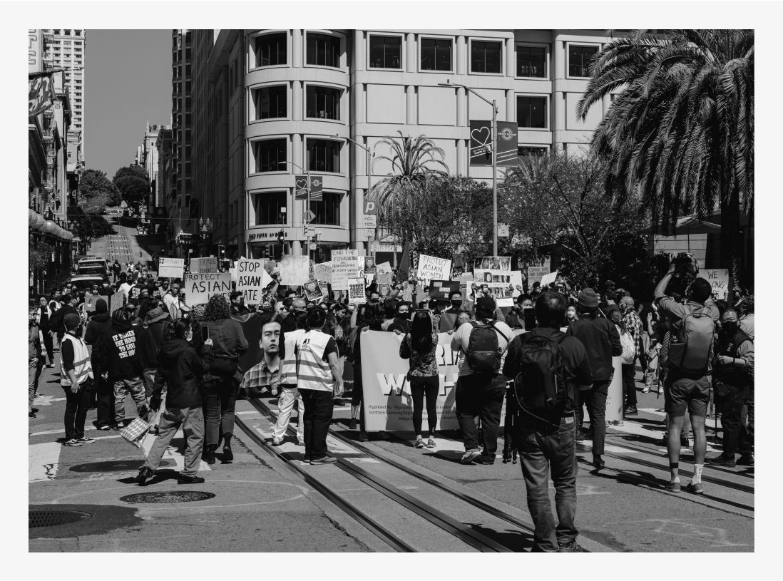 A group of people in San Francisco holding up signs to stop Asian hate